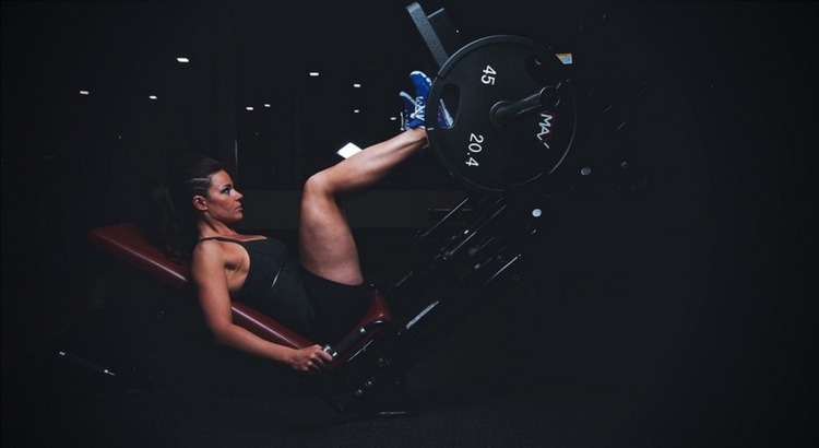 Person using equipment at gym to make their leg muscles stronger